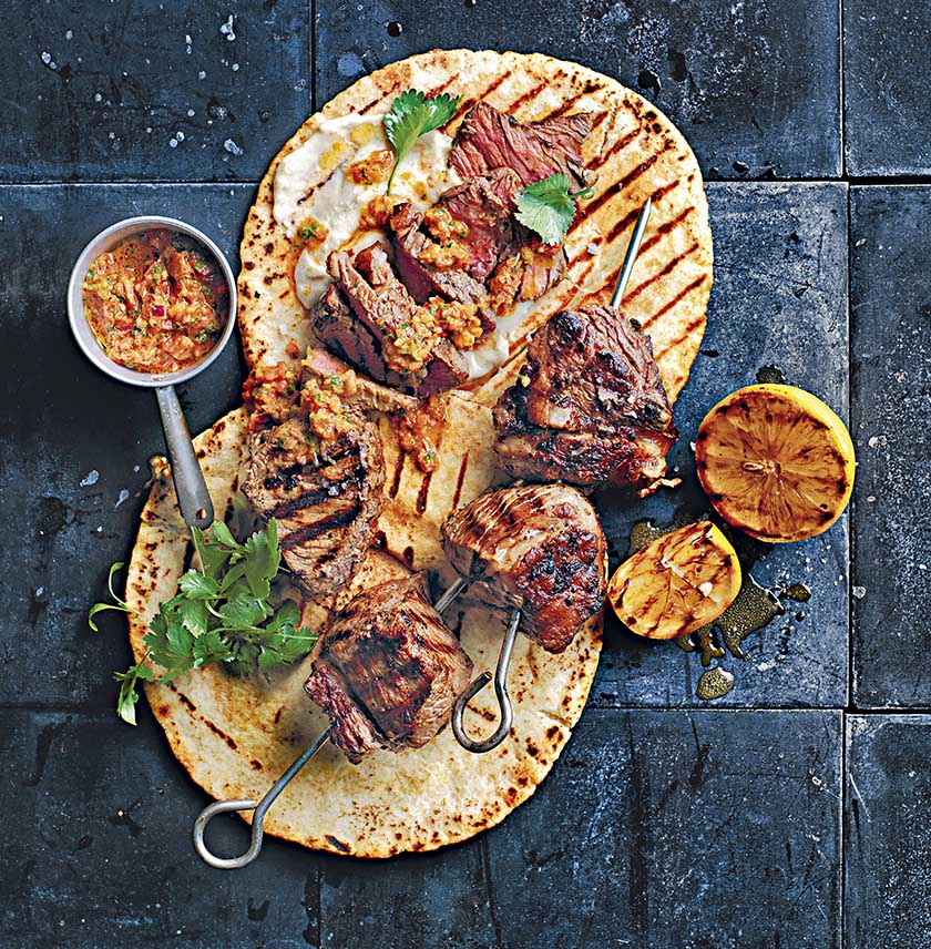 Grilled beef skewers with red chimichurri