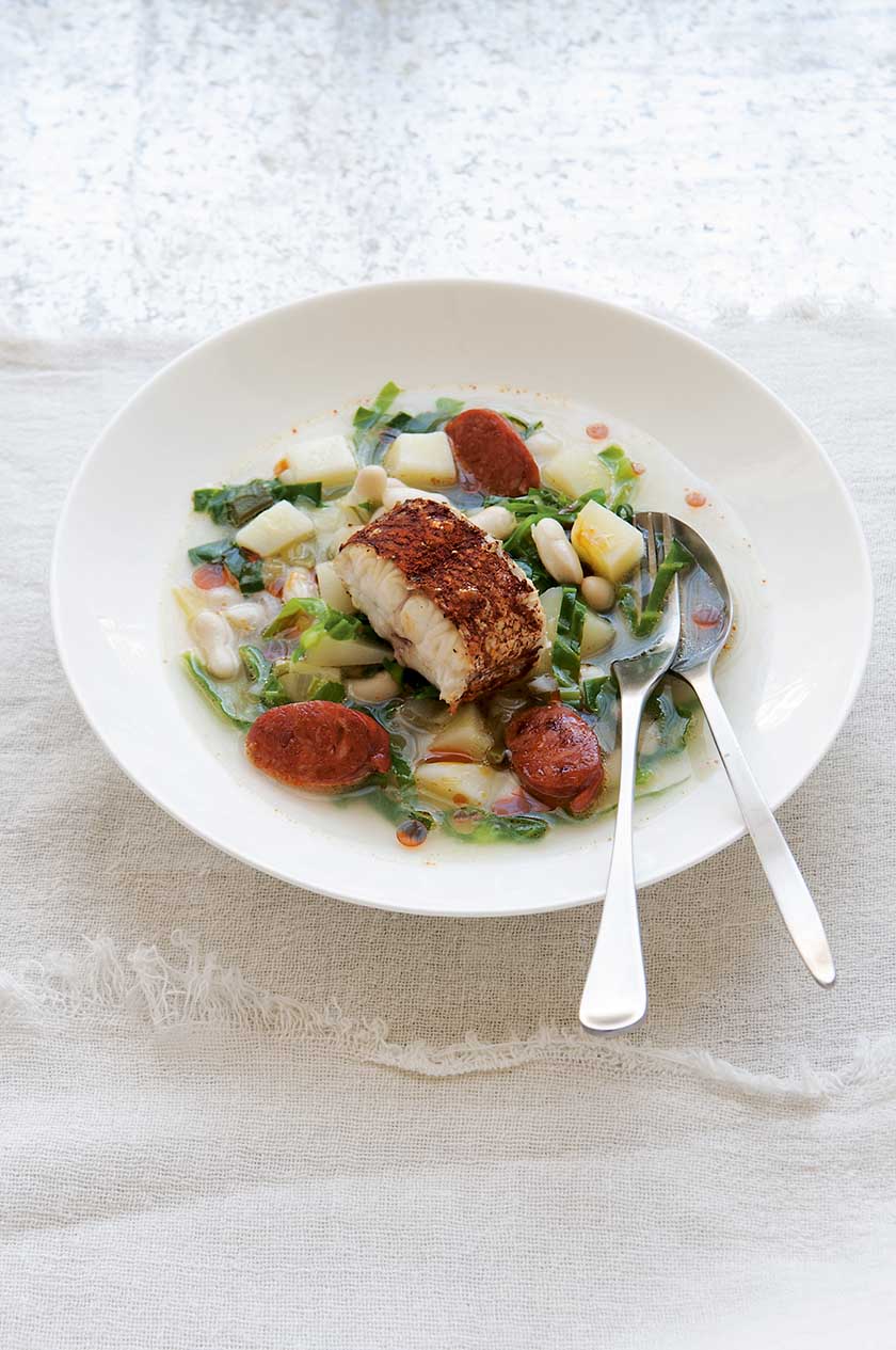 Smoky hake tail steaks with bean and chorizo broth and shredded greens