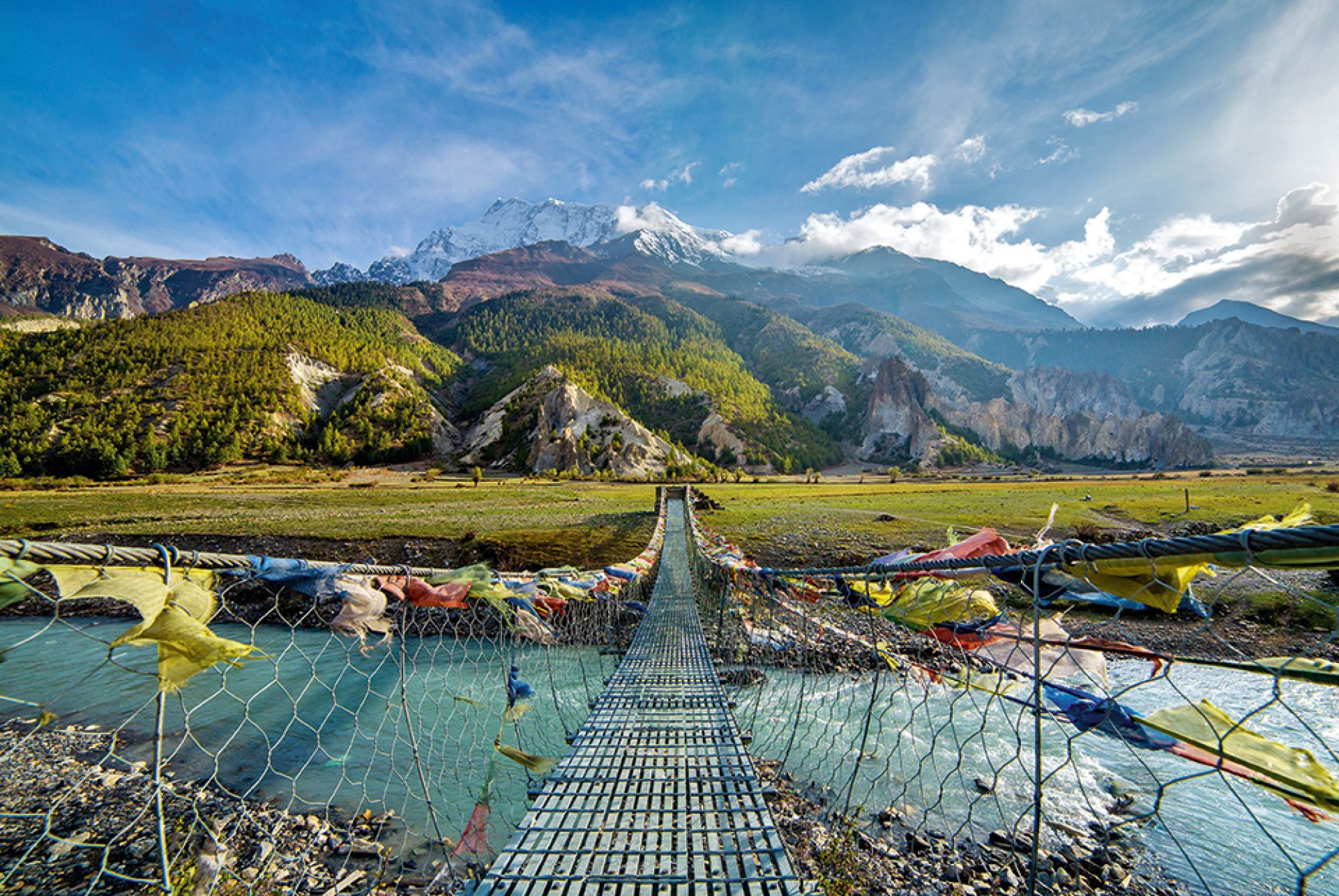 Suspension bridge with buddhist prayer flags Annapurna