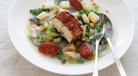 Smoky hake tail steaks with bean and chorizo broth and shredded greens