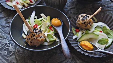 White miso and black sesame chicken balls with fennel and cucumber salad and carrot dressing